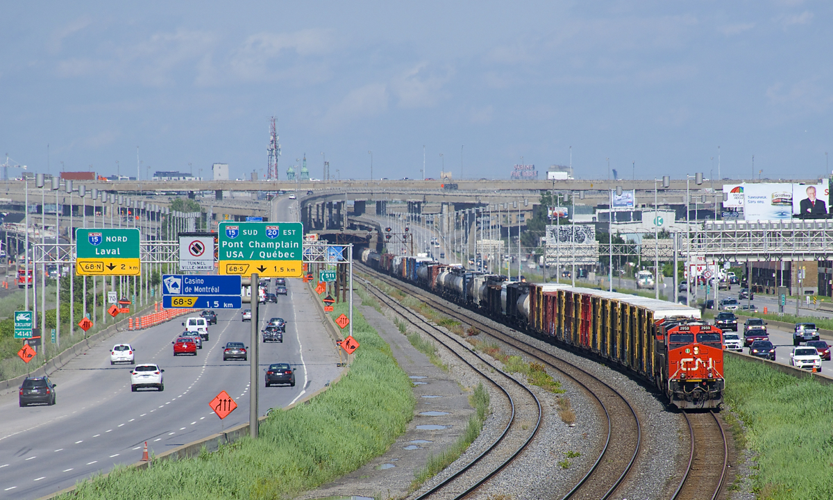 CN 2959 is leading CN X321 (with CN 2945 trailing) as it heads west on the Montreal Sub with 104 cars worth of overflow traffic from Southwark Yard, it will also pick up 32 more cars at Coteau.The lead unit is one of 25 ES44AC's (CN 2951-2975) built by GE in 2015 that are restricted to Canada-only service, as they are not subject to specific EPA emissions rules.