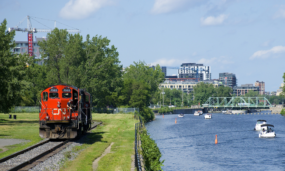 CN 7083 & CN 7054 head light on the East Side Canal Bank Spur after dropping off eight cars at the Robin Hood Flour Mill (the last client on this line). At right is the Lachine Canal.