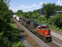 A quite late CN 310 approaches Turcot West on the north track of CN's Montreal Sub with traffic for Southwark Yard and Joffre Yard. Power is CN 8824 & CN 5788; the former sports a bit of a smiley face on its nose.