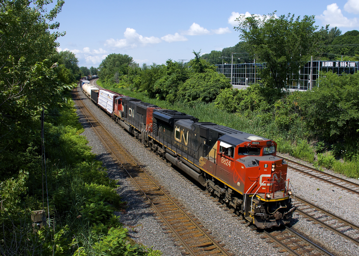 A quite late CN 310 approaches Turcot West on the north track of CN's Montreal Sub with traffic for Southwark Yard and Joffre Yard. Power is CN 8824 & CN 5788; the former sports a bit of a smiley face on its nose.