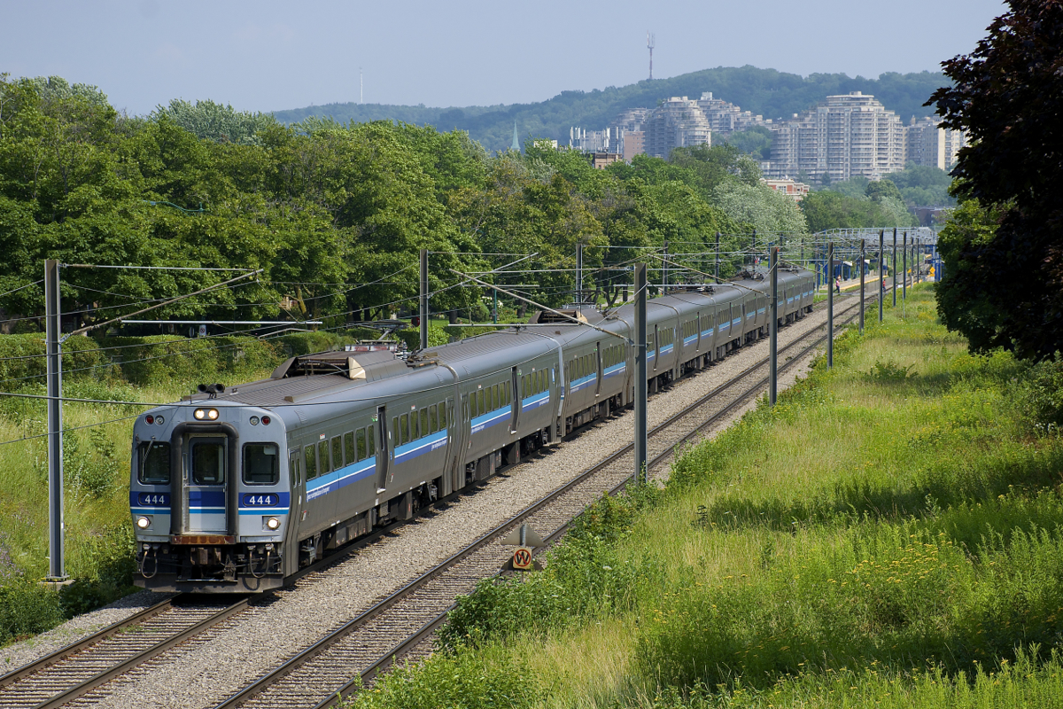 The Deux-Montagnes Sub is the only electrified commuter line in Canada and commuter trains on the Deux-Montagnes and Mascouche lines pass through this section of track. Here a AMT 939 consisting of 10 MU cars heads through the Town of Mount-Royal, heading for Deux-Montagnes. In the background is the town's namesake.