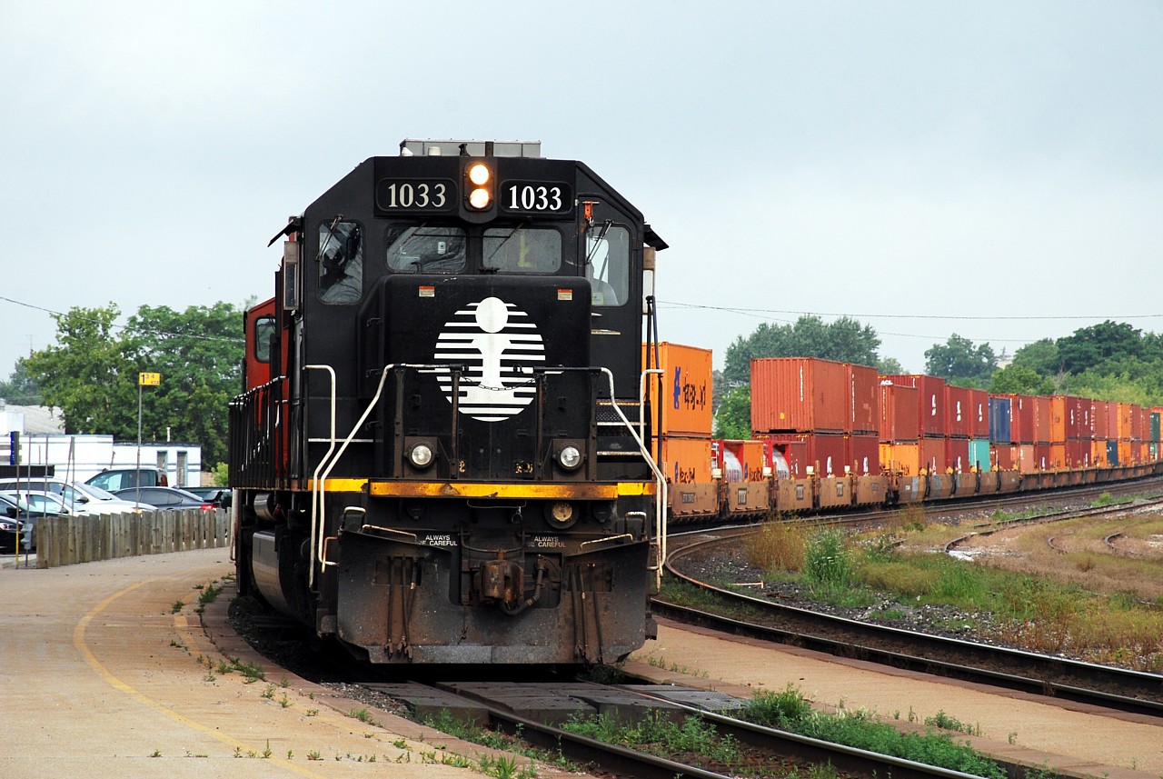 IC 1033 is in charge of CN 148 rounding the curve in front of the station in Brantford.