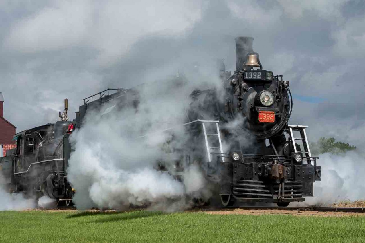 As a celebration of Canada's 150th anniversary as a nation, the Alberta Prairie Railway (APR) joined with the Alberta Railway Museum (AMR) in bringing their two steam locomotives together to run double-headed passenger trains between Stettler and Big Valley, Alberta for a week around Canada Day in 2017.  The locomotives involved are the APR 2-8-0 #41 ex-Mississippi Railway, and ARM 4-6-0 #1392 ex-Canadian National.  These photos show the activity on their many runs between these two centers.  In this image #1392 leads #41 south out of Stettler.