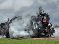 As a celebration of Canada's 150th anniversary as a nation, the Alberta Prairie Railway (APR) joined with the Alberta Railway Museum (AMR) in bringing their two steam locomotives together to run double-headed passenger trains between Stettler and Big Valley, Alberta for a week around Canada Day in 2017.  The locomotives involved are the APR 2-8-0 #41 ex-Mississippi Railway, and ARM 4-6-0 #1392 ex-Canadian National.  These photos show the activity on their many runs between these two centers.  In this image #1392 leads #41 south out of Stettler.