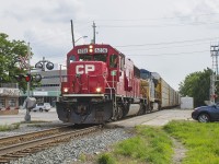 <b> THREE IN ONE!!! </b> A good tip always helps when trying to photograph trains...especially if you don't own a scanner. It's Friday evening, and I had just gotten off of work. I saw a text on my phone from my wife who works in Tilbury. She let me know there was a train slowly making it's way to Chatham. By this time, 20 minutes had passed between the time my wife sent the text and I received it. I knew the train was coming...
<br>
<br>
Inspired by a Bruce Mercer photo taken at King & Adelaide Streets downtown Chatham some 30 years prior, I setup shop on the opposite side of the tracks <a href="http://www.railpictures.ca/?attachment_id=29749"> from where he took his photo.</a> Just in the foreground remains the rails to what was the station lead. The station itself would have been straight ahead of me directly across the intersection. It is now marked by a mature growth of trees. And in rolled the train I had been waiting for...former SOO SD60 6036 (now CP 6236) with CSX 40 haul their auto racks past me. Canadian Pacific owned and yet a former SOO with the CSX as it's second in command. Awesome start to the weekend. 