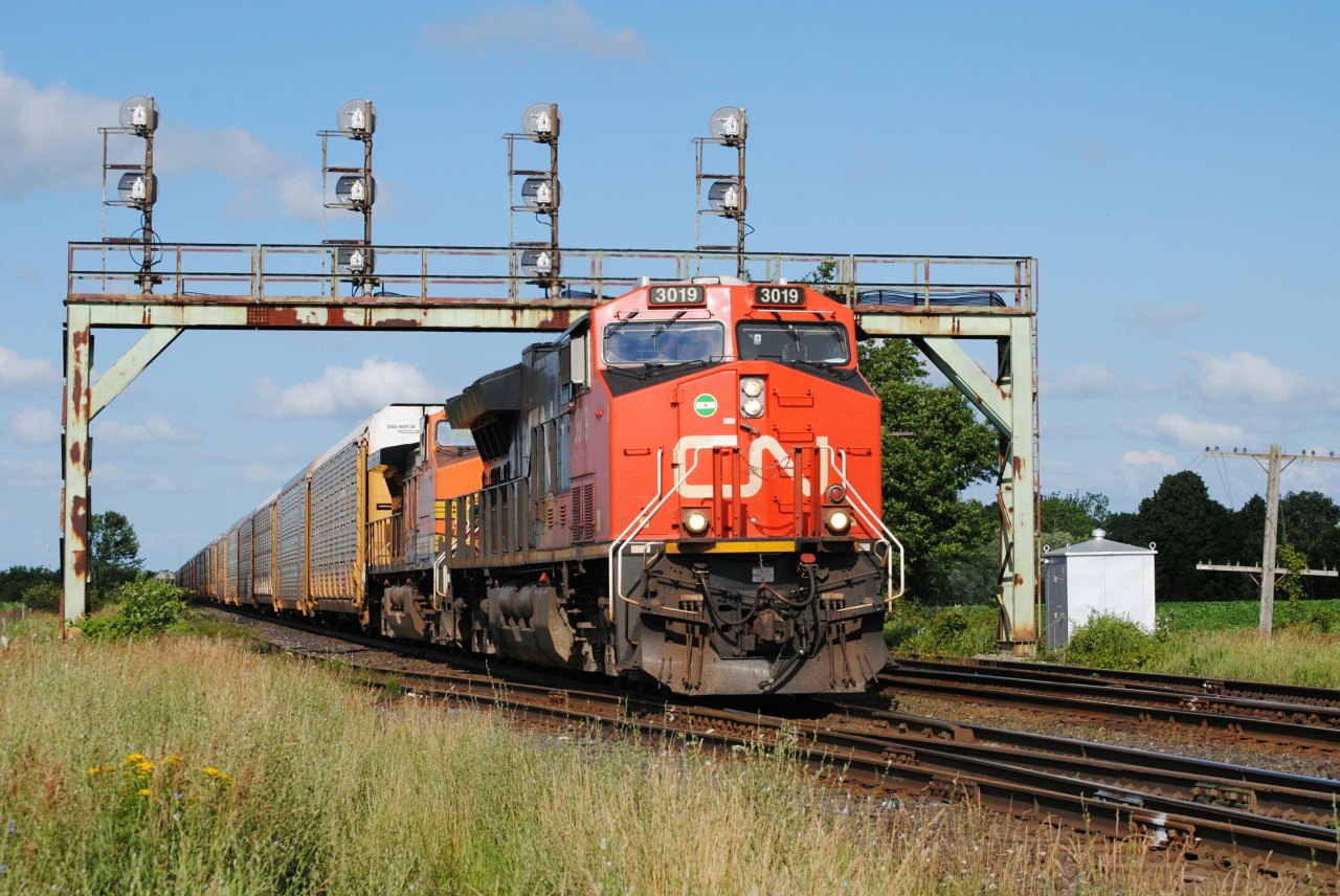 As I got to the tracks, ATCS displayed a clear block for a westbound. As I got to the tracks, I noticed CN E271 approaching with a touch of orange in trail!