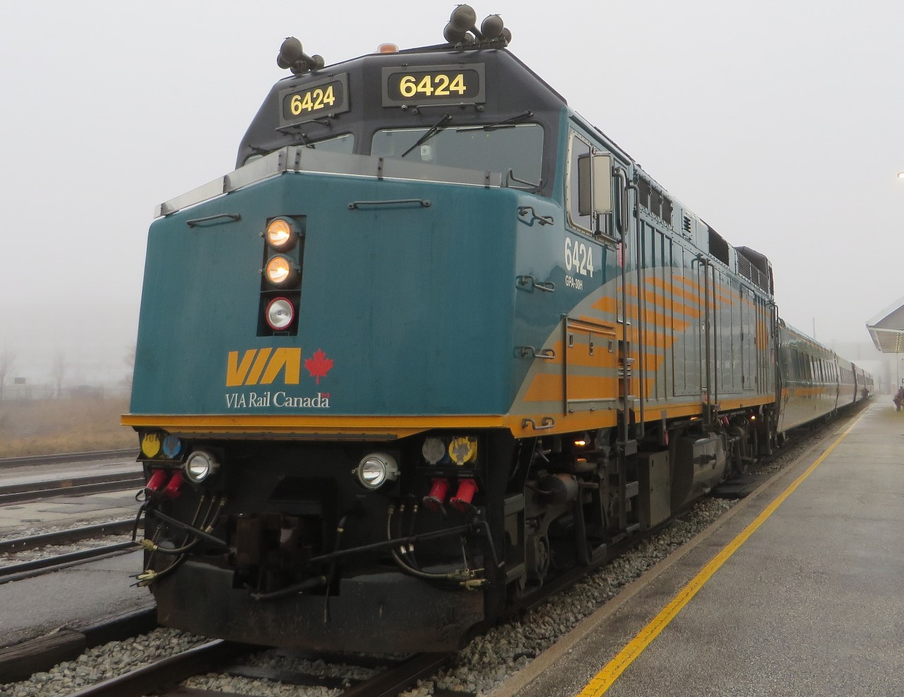 FOG SHROUDED F40. While waiting to board VIA # 72 to Toronto following a weekend of Original Six hockey in Detroit, this Newfoundland Railfan and his 3 travelling companions from the Rock were quite surprised to find the Windsor Station fully enshrouded in fog! Indicated by the twin beams of light from 6424 piercing the droplets, the four had mistakenly believed that they had left this type of weather back on the Island while they enjoyed the rail journey - a very pleasant part of each yearly hockey trip.