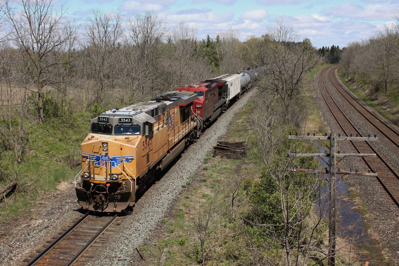 CP 647 with UP 5543 (AC45CCTE) and CP 9607 (AC4400CW) passes under Denfield Road as they prepare to stop at ESS Lobo. The conductor had to line the points for the siding so that they could meet a 244 which also had a UP leader.