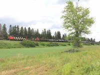 It's getting extremely rare to see these old cowls in these parts, much less leading no less!  Here we have CN 406W passing Allison, NB en route to Saint John with a short 2580 foot over-powered train rolling down hill with the dynamics blaring.  Once these guys pass the next crossing they will throttle up to 40mph for the next 175 miles to their destination.