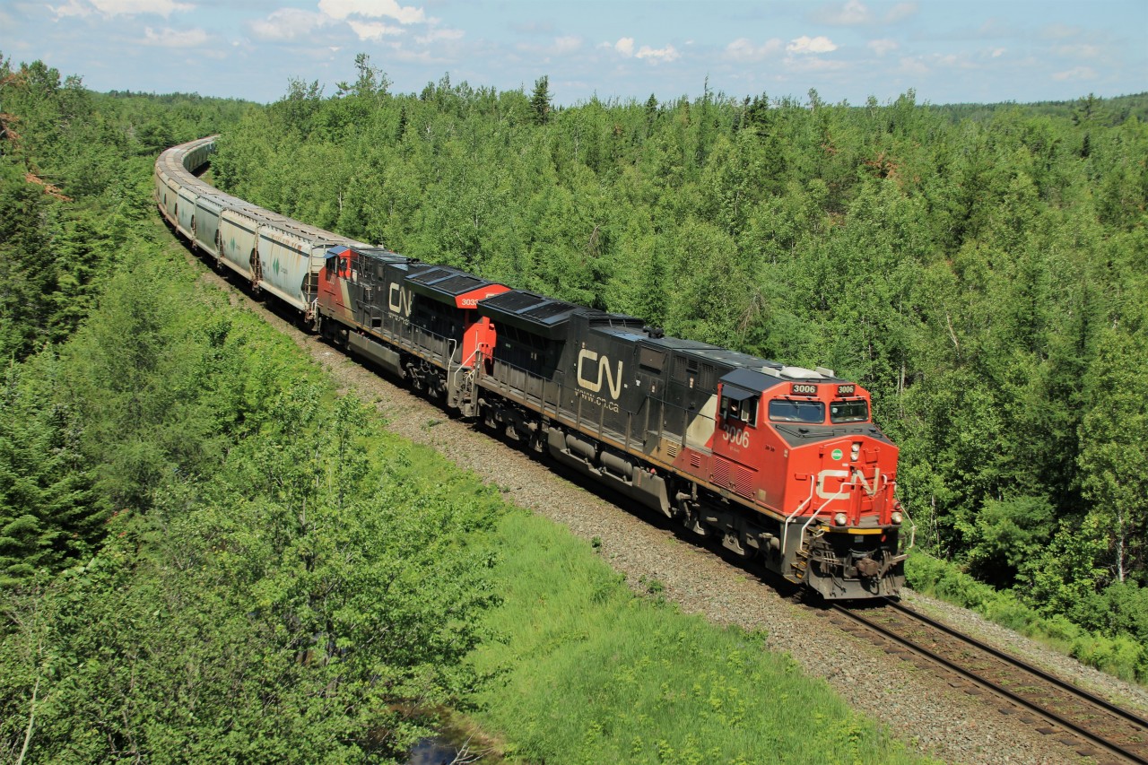 CN 3006 leads an eastbound B730 unit Canpotex potash train just under the TCH overpass nearing Gordon Yard.