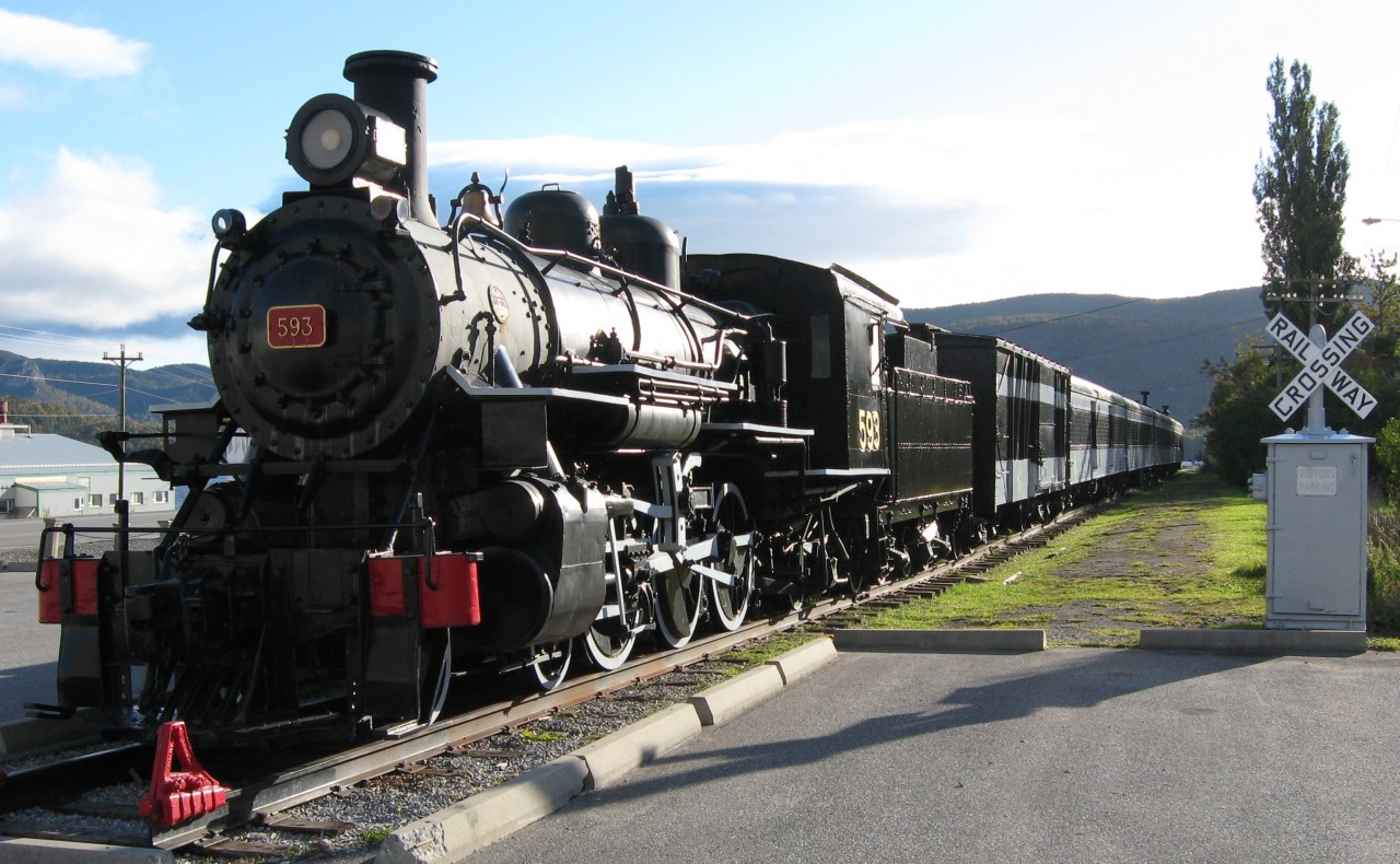 STEAM SURVIVOR. Former CNR 593, a Pacific Class 4-6-2, is the only surviving steam locomotive from the Newfoundland Railway and has found a safe home on static display at the Railway Society of Newfoundland's Historic Train Site in Corner Brook. Originally delivered as # 193 for the NR in 1921 by the Baldwin Locomotive Works for the sum of $36,870.00 as a passenger express engine, it remained as such until the arrival of the larger and more powerful Mikados started to arrive in the 1930's. After years of branchline duty pulling mixed trains, it ended it's career as a yard switcher in Port aux Basques with some 1.5 million miles of service behind her in 1957. Accompanying this beautifully restored engine and her tender on the narrow gauge mainline at the Humbermouth Station are Box Baggage 1598 (Eastern Car, 1954), Baggage-Express 1600 (CC&F, 1943), Coach 758 (CC&F, 1949), Diner 10 (CC&F 1943), and Sleeper 'Twillingate' (NSC, 1938).