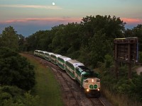 Despite my young age, I'm lucky enough to remember somewhat when Niagara Falls Yard was full of yard power and cars, with a Conrail or NS unit sitting here or there. Seeing how it looks today, I usually prefer to look away from the yard. Looking the other way, there is surprisingly still two tracks leading up to Niagara Falls station. The bright green weeds to the left of the tracks is the former yard lead, with ties poorly visible. The only reason the second track likely still exists is due to conflicts between the Amtrak Maple Leaf and weekend evening GO train in which the Amtrak is often delayed. While the yard is gone, and barely any track or trains remain in Niagara Falls, the Amtrak and GO trains still trundle their way around the curve here. On most days it is just the Amtrak however.
<br><br>
Here, GO 557 bobs its way around the curve towards Clifton having just departed Niagara Falls with weekend GO train 782. The F59PH's are now starting to make their mark around Niagara Falls having been mostly absent over their 29 year history. In just a few short years however, even these units will go the way of Niagara Falls Yard. 782 is just exiting the 10mph zone, which exists because it is dark territory on a blind curve. With dirt bikes that frequently cross between the two switches, corn field meets probably aren't the only thing the 10mph limit has prevented. Speaking of which, dirt bikers had crossed just moments before the GO popped around the curve.
<br><br>
The angle of the full moon suggested that this location would be nice to shoot from for once. Typically I'd avoid Niagara Falls altogether when railfanning for obvious reasons. 