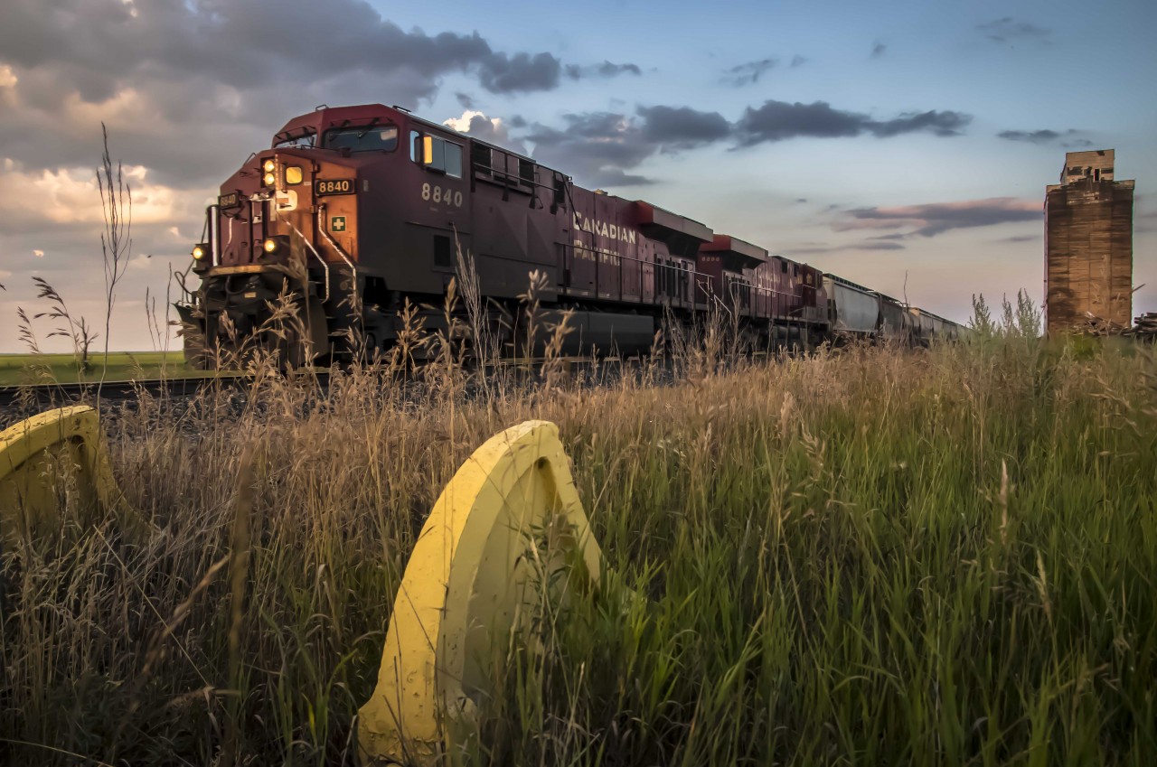 "Passing Generations". 

A derelict elevator scheduled for demolition and an obsolete spur track is passed by a modern era.