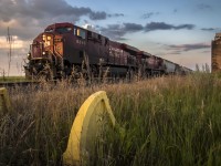 "Passing Generations". 

A derelict elevator scheduled for demolition and an obsolete spur track is passed by a modern era. 