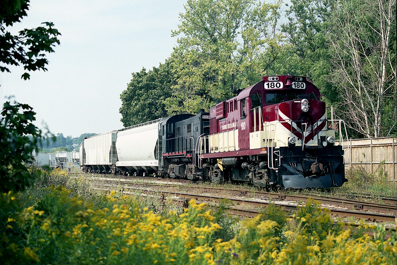 OSR 180 and 506 working on the Guelph Jct Rwy switching the Polymer Distribution Inc yard in SE Guelph on a nice fall day. The goldenrods add a little colour to the scene. I understand the 180 is now out of service.