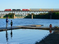A father with his sons spending time fishing the Grand River while a train passes over downtown Galt on a cool summer evening.<br><br>
Gotta love these summer evenings. My summer routine allows me a few nights to try my hand at a photo from the north side of River Bluffs Park in Galt - <a href=http://railpictures.ca/author/corncitymofo> Bill Miller</a> turned me on to this spot a few years ago and normally a couple trains was easy, four was a good night. Now if you get one, you are doing well - things really have changed on the 'ol CP. This was my fourth attempt this season, and my first getting a train before the sun sets for good. With this in hand any evening photography I do in August 2017 will have to be elsewhere - this sure is a keeper. 