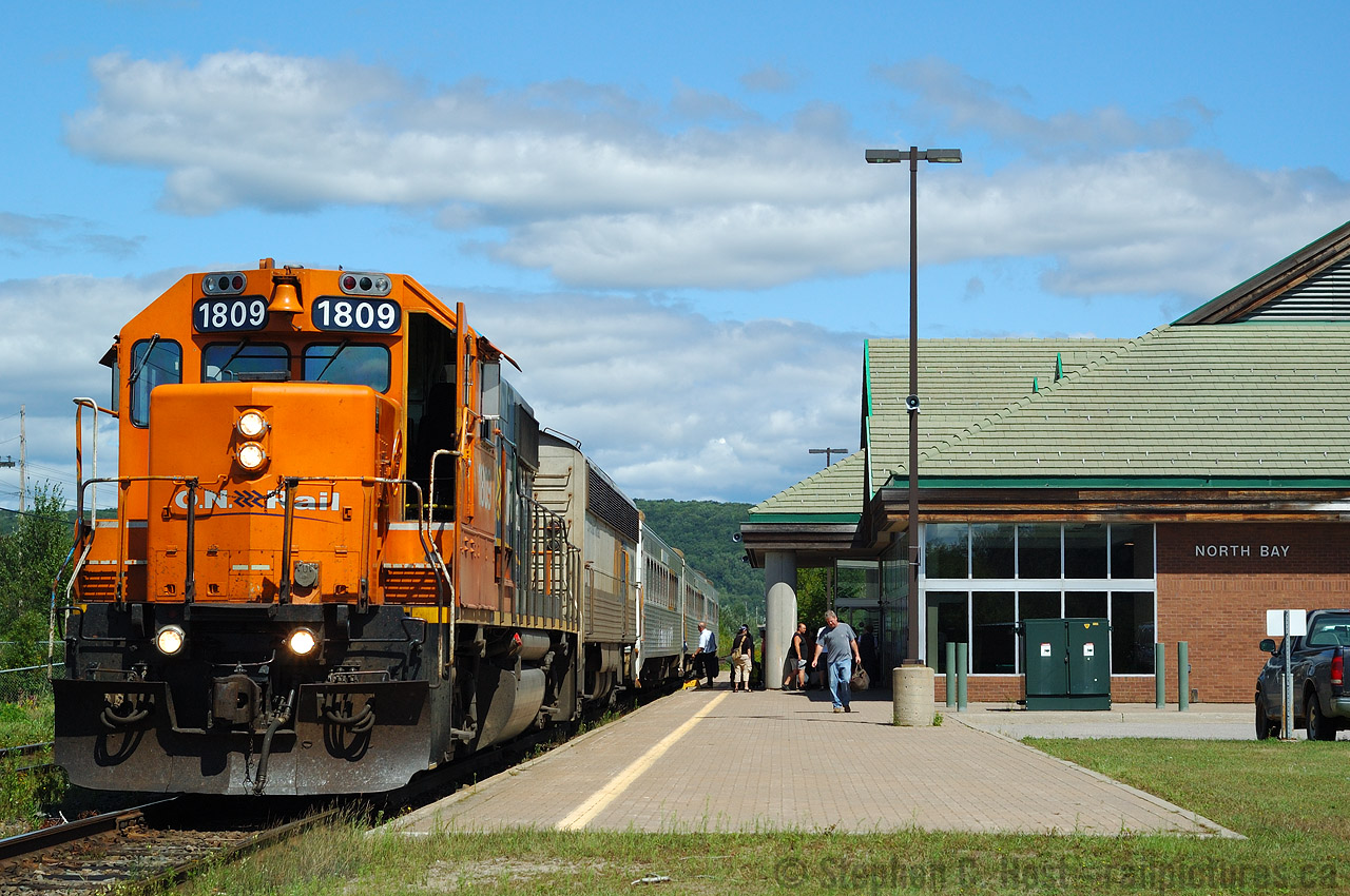 Before the rumours, before the eventual loss, and the heartbreak a quiet scene at the North Bay station as Train 698 prepares to depart North Bay on a nice summer day. The Engineer is walking up to the head end with his bags and a few passengers are boarding for Toronto. Now this station is a glorified bus station. It could very well host trains again, but I don't know too many people holding their breath. It's too bad the North gets neglected while hundreds of millions are spent on pork projects in the South, like giant stations such as a $50-100 million dollar middle of nowhere Monstrosity at Bloomington Click here to see - but be warned for those on blood pressure meds! on the Richmond Hill line. Metrolinx was once a fairly sensible operation but now the money being spent is just idiocy. The Northlander cost Ontario about $10m a year or 86 cents per person in tax dollars.