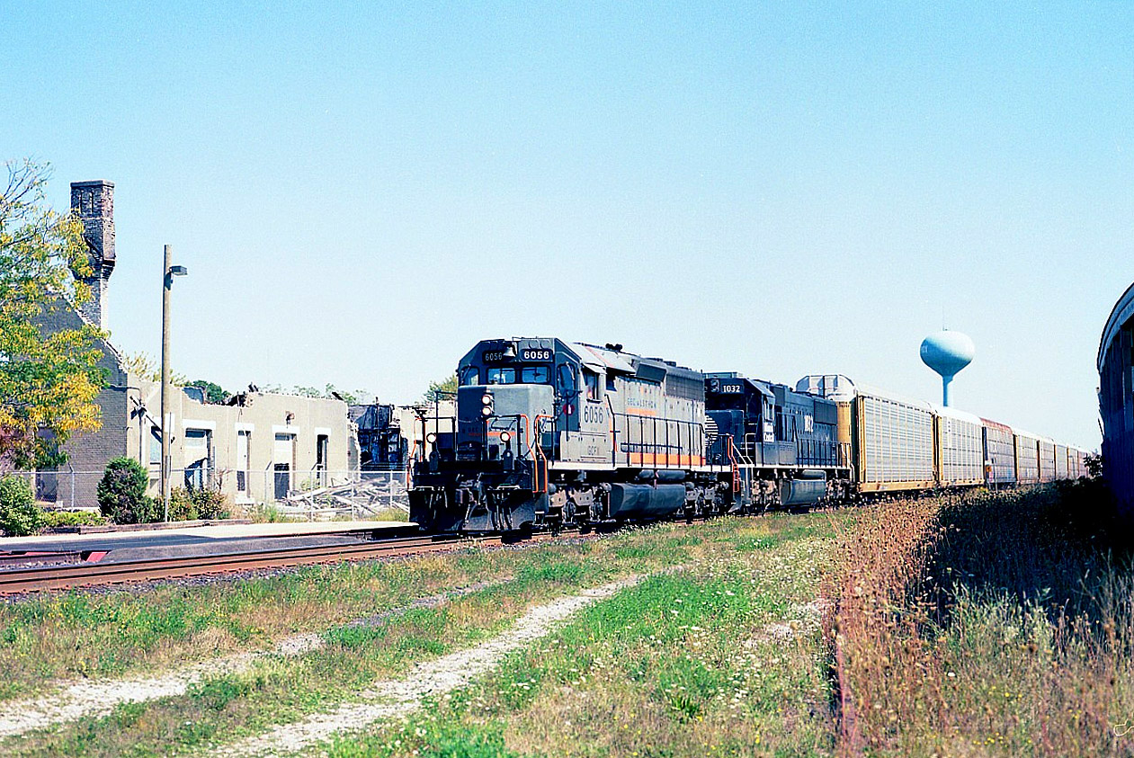 This morning (posted 07/19/17) CN had a major derailment around 0430 right at this location as the last 13 cars of an eastbound left the tracks right by the VIA shelter platform. This view of a westbound 13 years earlier here shows Alstom (GCFX) 6056 and IC 1032 powering a train past the remains of the historic Strathroy station, destroyed earlier in 2004 by arson. The remains have since all been removed.