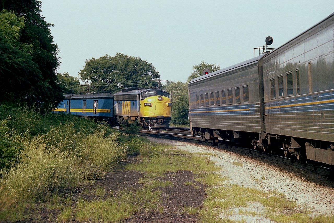 It really bugs me that I have misplaced my notes.  It was one of those mid-week occasions in which I had the day off and the junction mostly to myself. I DO remember a passenger train not showing up when expected, but I cannot recall which one. This is most likely #73 on the south track very late catching the #83 that used to run mid-afternoon. However, I would have expected the VIA 6507 to overtake the #83, (led by VIA 6903) but that didn't appear to be the case as the trains rolled out of sight westbound over Hwy 403 thru Hamilton West.(On the schedule, 73 was  1 1/2 hrs ahead of 83) A most unusual image for me, and I was very lucky to be standing where I was, totally unaware the 6507 was on the heels of the 6903. Some days are like that. Incidentally, in the foreground one can see where ties had just been lifted from what used to be the old 'helper track' from steam era days.