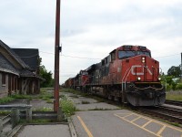 CN train 394 crawls pass the run down old CNR Station in Ingersoll, Ontario. It is sad the disrepair the station has fallen into. 