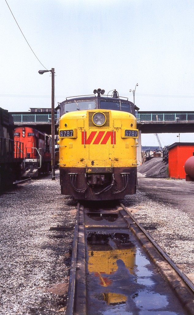 VIA 6787 and her reflection are in CN's Spadina engine facility on July 4, 1981. VIA 6787 (MLW FPA-4) was CN's 6787.