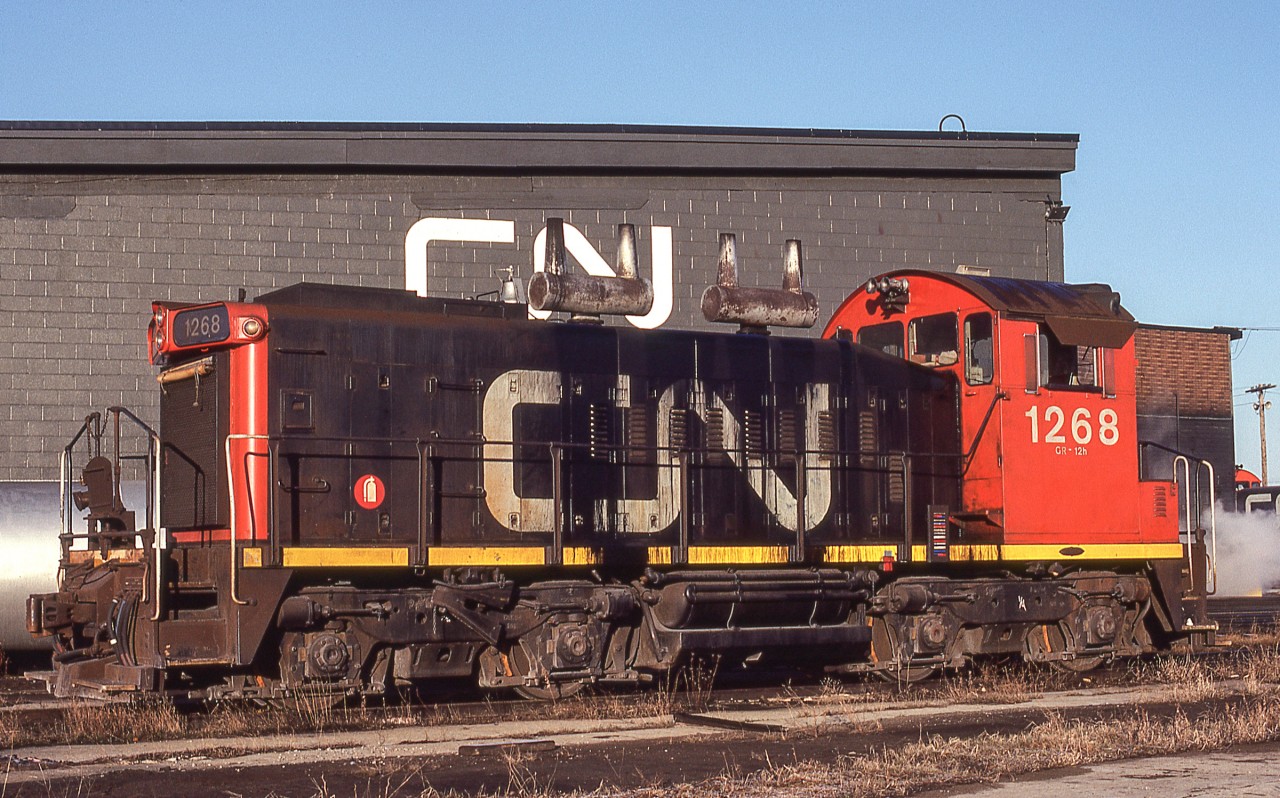 CN 1268 sits in the early morning sun in London, Ontario on March 25, 1981. By noon heavy clouds would fill the sky, but it was early morning with the sun's golden glow still somewhat present.
