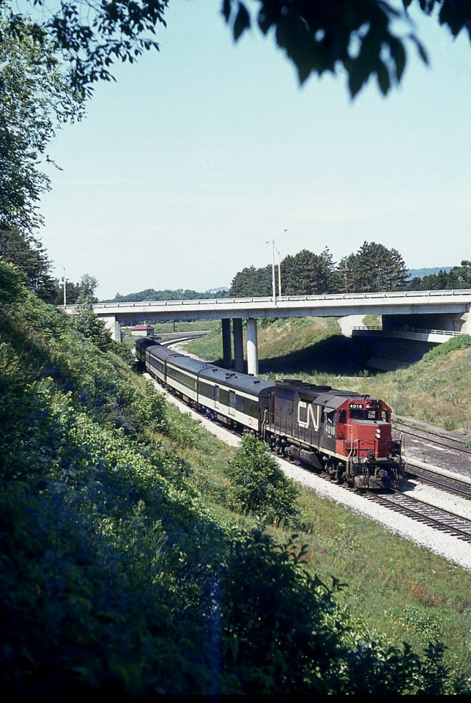 Back in the 1970s when a couple of CN GP40s were geared for passenger service on CN, we saw them rather frequently. After all, this was pre-VIA, and anything goes. It was either 4016 (pictured) or 4017 making an appearance almost like clockwork down by the Jct. Out of many old images, I selected this one to upload because I felt it was almost a throwback to the quiet days of the past. It just doesn't look like it is actually shot in the city, per se. Rather, this could be quiet countryside anywhere in rural Ontario. That is the now busy York St overpass in the background, and I am standing on the hillside that overlooks, just to the right out of view, the junction itself. It is still early summer and purple flowers, which will coat the hillside, are just beginning to show their colours.  The 4016 and 4017 were renumbered to 9316 and 9317 in 1981. Off roster by 1998.