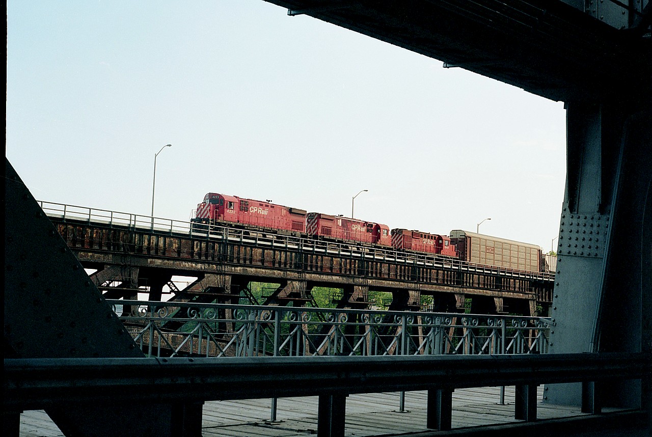 I have to admit it. I rarely get luckier than this. Back in 1994 the cross-border shopping experience was almost a frenzy. There were lineups both ways on the bridges with the one-day shopping trips. I had been over to get gas at 'Smokin' Joes' as well as pick up a few groceries. So here I am waiting on the Whirlpool Rapids bridge, about centre, heck, maybe still in the States; and out of the corner of my eye I see a train bound for the US!! And I am in a perfect position to shoot right out the car window. CP 4223, 4224 and 1848 come into view and this is the result. Camera handy on the front seat, as always. And it paid off.  This was the best shot I was able to get from this bridge, and it can never happen again. The rail bridge is abandoned and the road bridge is Nexus Card only.