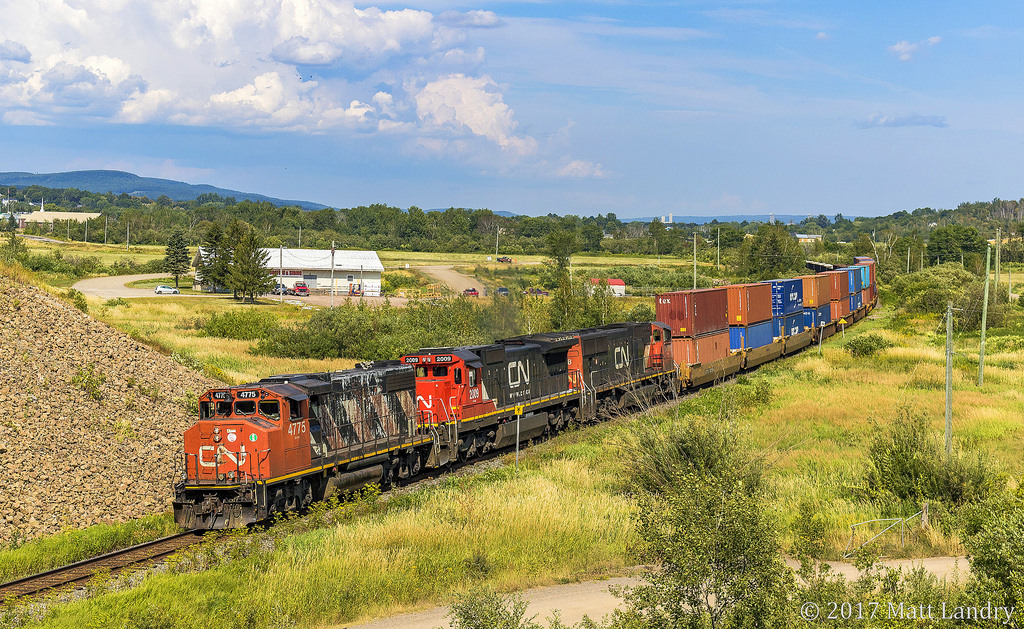 CN 4775, and old warrior, leads westbound train 406, as they pass under Highway 1, after heading through the town of Sussex, New Brunswick.