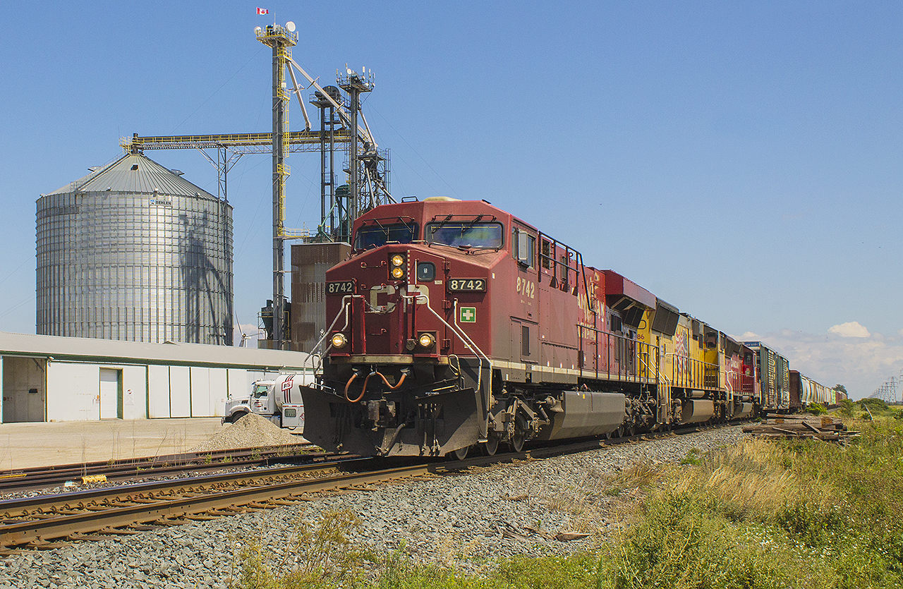 Hard work DOES pay off!!!  My day began with a casual drive, out to see if there was any action around. My intent was at least trying to catch both the afternoon VIA trains, 76 & 73. However, at Dhillon road a long eastbound CP 650 was stopped, and slowly took the siding leading up to Bloomfield Road. Knowing that there may be another hot shot eastbound, or even better a westbound, I picked my spot in downtown Chatham to shoot from. I only got as far as William Street, and the barriers had come down as 235 was rushing west! I immediately pulled into a grocery store parking lot, turned around, and chased 235 all the way out to Haycroft. And still only had a quick few minutes to spare due to local traffic. It was worth it, as there were three engines leading this charge in CP 8742, UP 5086 and CP 5023. This is about as rare as three trains running daylight for the CP these days!