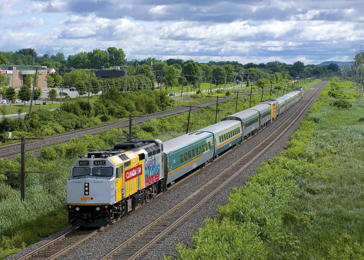For what may be a first time, a VIA Rail train (VIA 633) has three wrapped units (albeit split up), with VIA 6437 up front, VIA 900 mid-train and VIA 912 bringing up the rear as it heads west through Pointe-Claire.