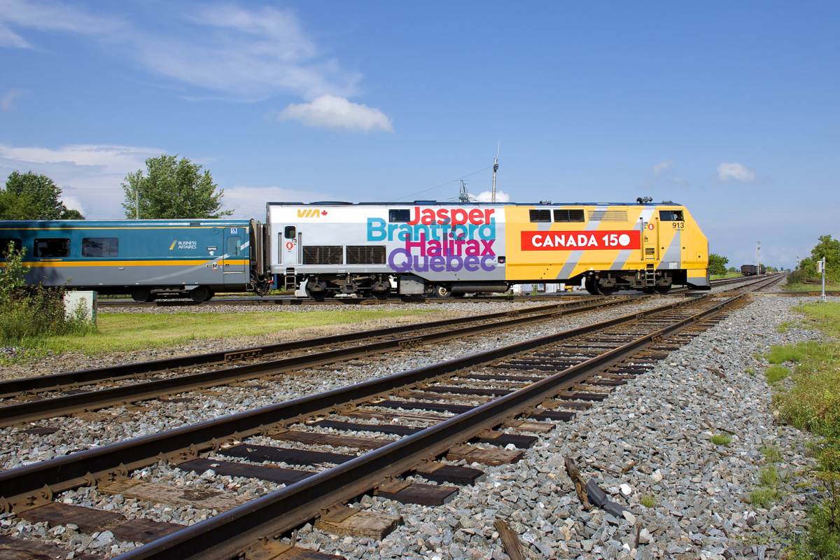 VIA 26 with wrapped unit VIA 913 clatters across CP's double track Winchester Sub where it is crossed by VIA Rail's Alexndria Sub (originally CN).