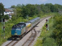 A late VIA 35 is splitting the signals just east of Ottawa Station with the only VIA first class car to be wrapped, in a unique scheme (VIA 3476). 