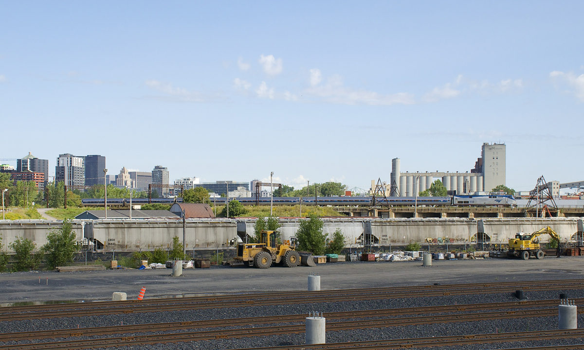 AMTK 68 (694 while on CN tracks) has just left Montreal's Central Station and is passing the Pointe St-Charles Yard on the elevated portion of CN's St-Hyacinthe Sub. Soon it will take the Victoria Bridge and leave the island of Montreal.