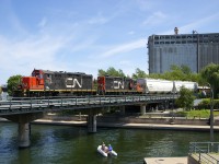 <b>Back to our regularly scheduled programming.</b> Almost exactly 24 hours after the CP Canada 150 train (with three F-units) crossed the Lachine Canal at this location to get to the Port of Montreal for its show, its back to normal as a CN switcher enters the port with a pair of matching GP9's for power (CN 7032 & 7054).