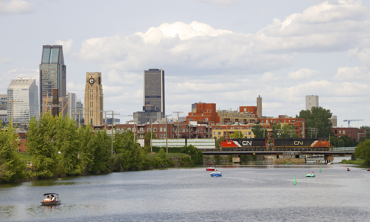 CN 324 with CN 2434 and very clean CN 9592 crosses the Lachine Canal, with part of Montreal's downtown skyline visible in the background.