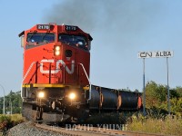 The C40-8W's were still relatively new to CN rails and it didn't take long for a number of them to become captive on the Thunder Bay runs. Here we see CN 2170 (leading CN 2102 and a couple dozen grain hoppers after setting out most their train in Neebing yard) past the Alba station name sign; which signifies the east end of Neebing yard and the switch for the CN Mission Spur. The crew will run across town, tie down the balance of their train, park the power (likely on the east leg of the Port Arthur wye) and call it a day.