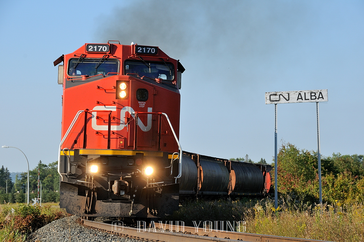 The C40-8W's were still relatively new to CN rails and it didn't take long for a number of them to become captive on the Thunder Bay runs. Here we see CN 2170 (leading CN 2102 and a couple dozen grain hoppers after setting out most their train in Neebing yard) past the Alba station name sign; which signifies the east end of Neebing yard and the switch for the CN Mission Spur. The crew will run across town, tie down the balance of their train, park the power (likely on the east leg of the Port Arthur wye) and call it a day.