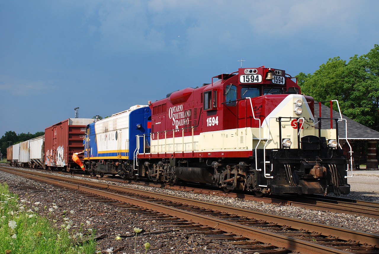 The skies clear after an intense summer thunderstorm as the OSR crew carries on building their train.