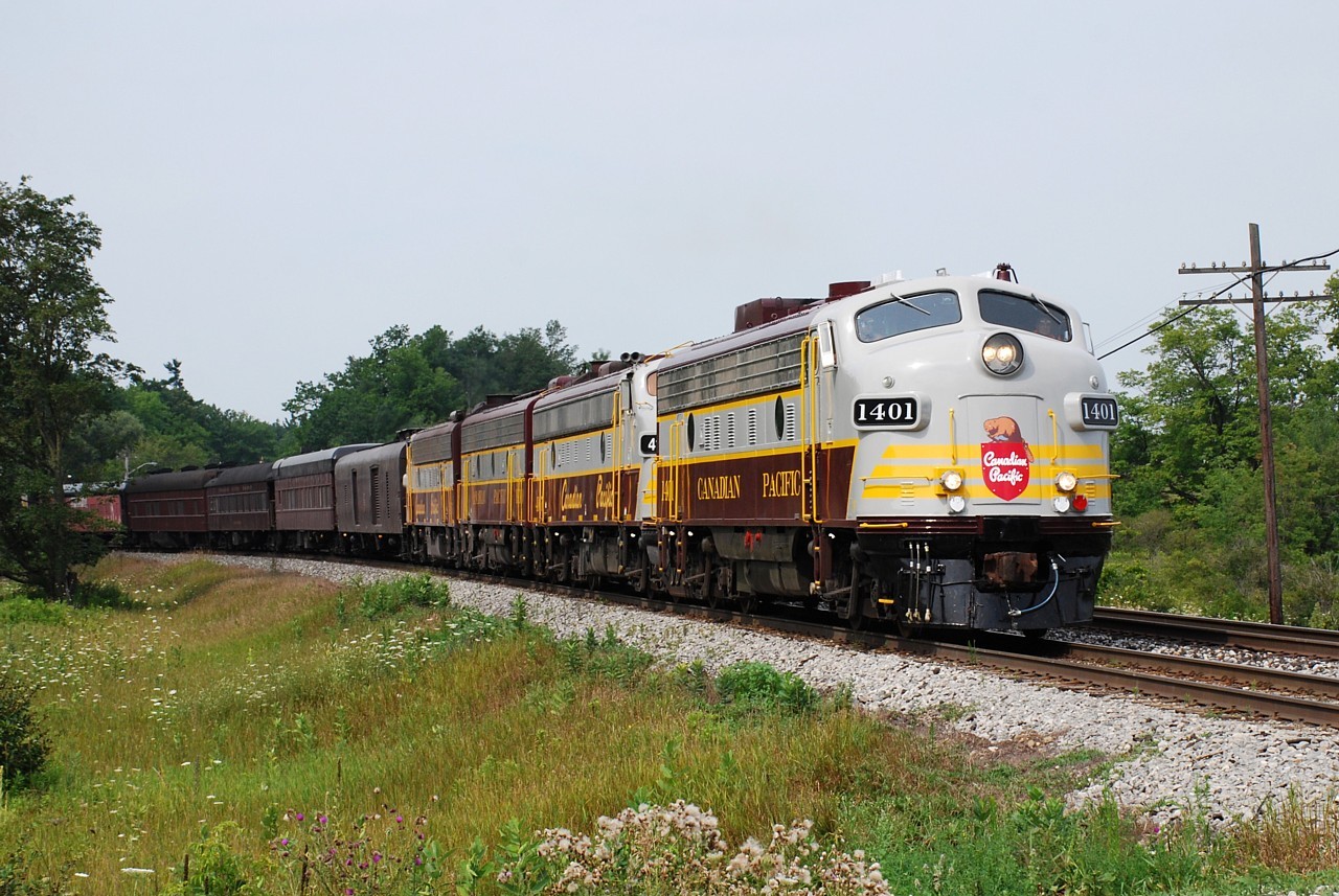 After the event in Hamilton on August 9, CP's Canada 150 train spent the night in Aberdeen Yard.  The train received a clearance right on the button at 09:00 the following morning, but it was soon discovered they had an air leak.  An hour later the train finally departed Hamilton, and an hour after that it got up to Guelph Junction.  The train is shown highballing on the Galt Sub. approaching Canyon Road heading east for Toronto.