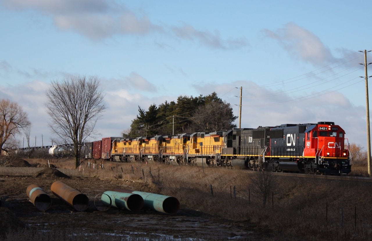it's not very often these days one can catch a solid consist of standard cabs but this day proved to be rewarding. Here we see a fresh looking SD60 5421 (ex Oakway Leasing) leading IC SD70 1020 and five ex UP Dash-8s heading to Toronto for storage, where eventually they well emerged in CN paint. The train is passing Mississauga Road and as luck would have it I just beat a cloud overhead to get this shot :)