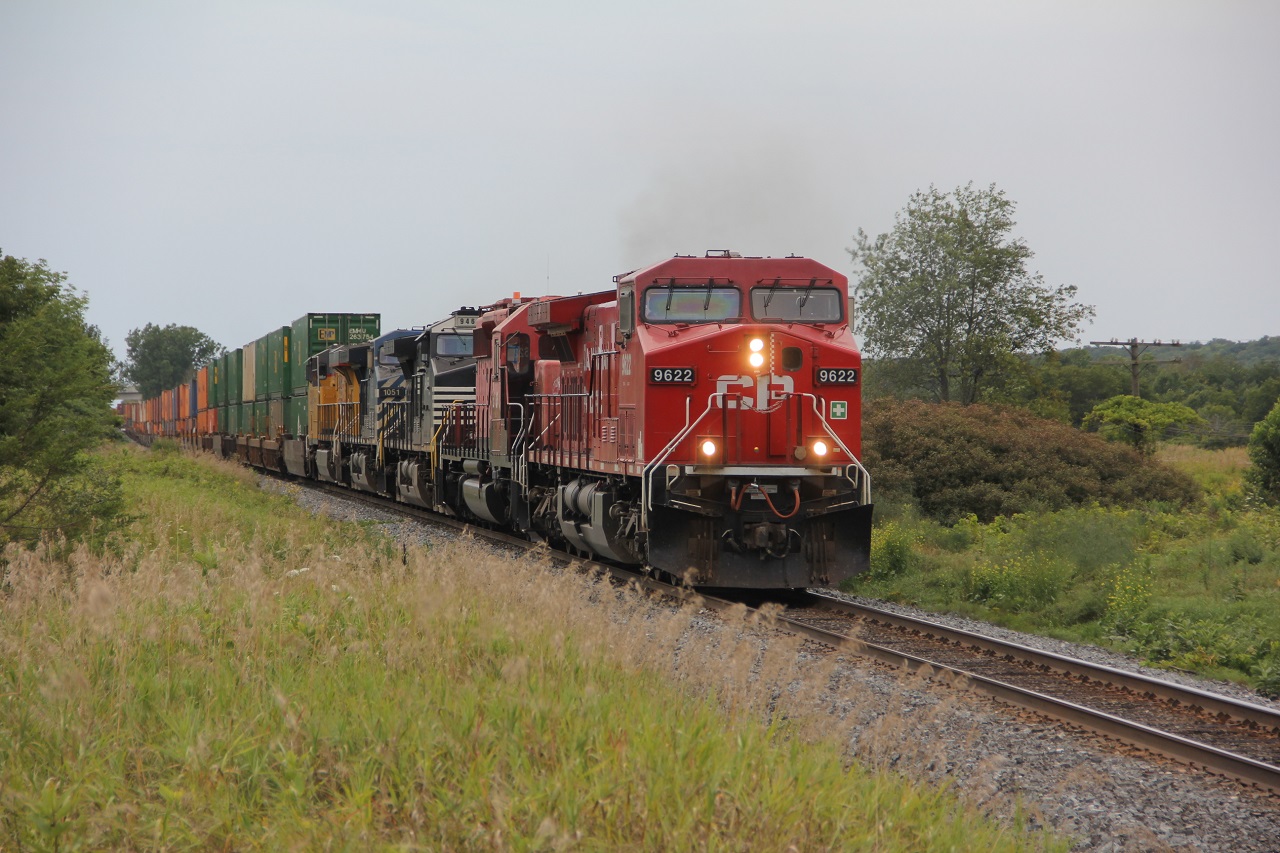 East bound approaching Trenton, 5 units, 5 different paint schemes. unaware and out of place for a nicer shot. As CP 6034 is off to destinations unknown.
