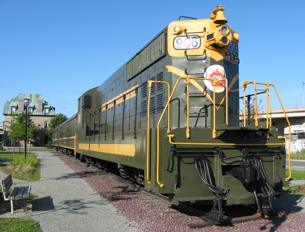 SAVED BY ST.JOHN'S. Thanks to the hard work of the Railway Coastal Museum, the Johnson Foundation and the City of St. John's, NF110 #906 has been given a third lease on life. Originally located in Bowring Park after being taken out of service, it fell into disrepair due to both vandalism and neglect. It has been beautifully restored to it's original green and gold scheme and along with RPO 1805 and Coach 763 (former NR # 46), sits outside the Victorian era granite station, now home to the RCM. Built by GMD in 1953 as one of nine of the series, the only other surviving sisters are 900 - located at Clarenville, and 902 -located at Lewisporte. The 906 had the honour of being one of three diesels which brought the last eastbound 'Caribou' into this very spot on the early morning of July 3, 1969.