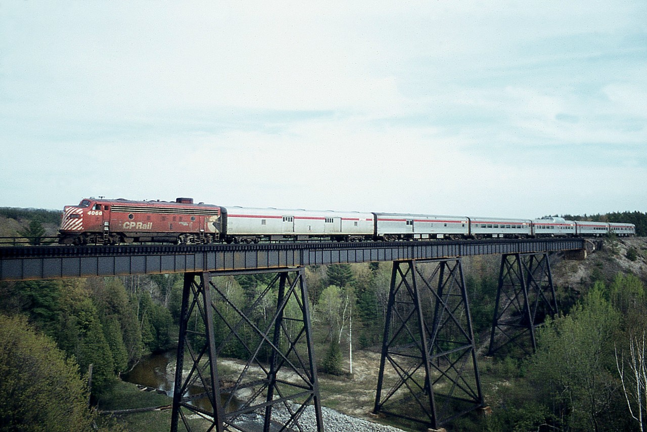 Toronto-Sudbury portion of the 'Canadian' behind CP 4066 makes its way north past the community of Midhurst on a pleasant June day. This unit was rather common around this 1976 time frame.