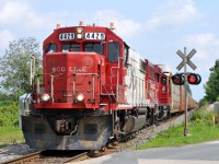 CP T78 crossing Township Road 6 en route to Pender with SOO 4429, CP 2319, and 32 empty autoracks for Toyota