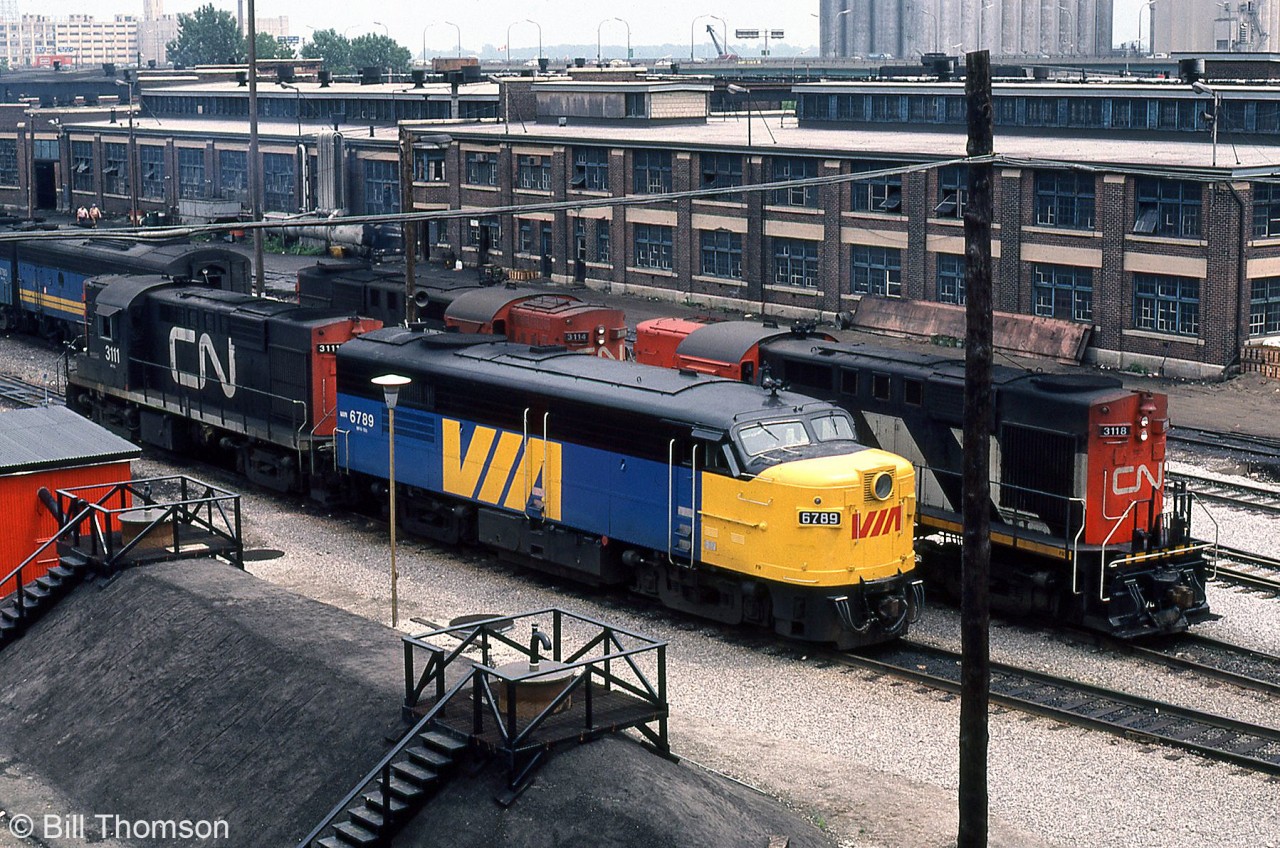 Ever since the steam era, CN's Spadina Roundhouse has been their main maintenance base for passenger power running out of nearby Union Station in downtown Toronto. This continued into the VIA era until the mid-80's when locomotive and passenger car servicing and repair facilities were moved to the new VIA "Toronto Maintenance Centre" in nearby Mimico (to make way for the Skydome construction).

Seen here on July 22nd 1980, VIA FPA4 6789 and other VIA power sits on the ready lines at Spadina Roundhouse with CN RS18's 3118, 3114 and 3111, also used in passenger service out of Toronto.