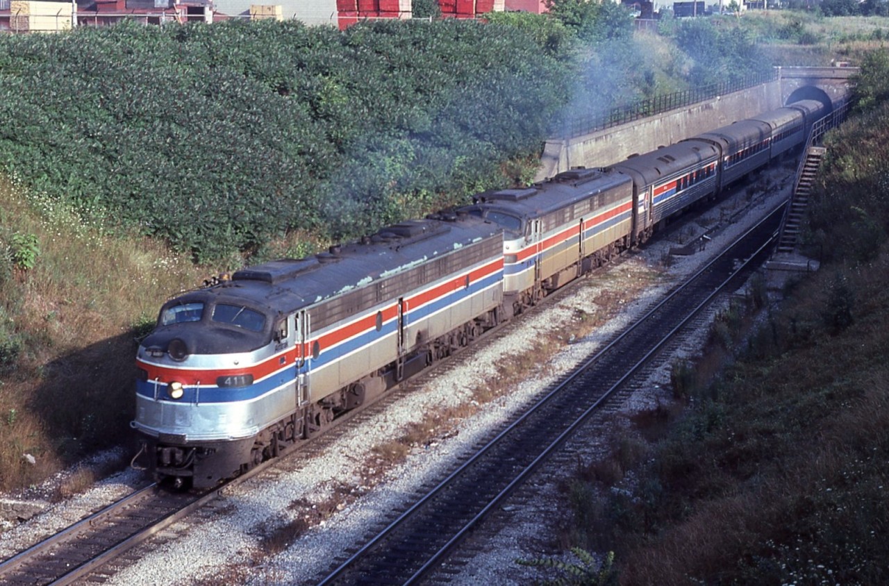 Amtrak No.64 (Detroit-New York City) exits the East Tube of the Detroit River Tunnel into sunny Windsor, Ontario on Aug 14th 1978.