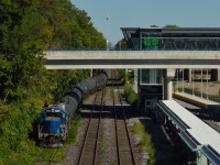 Opportunity is like a good photo...take it!  While visiting Hamilton to see what was rolling I was looking over Stuart Street Yard watching the NECR 3840.  As 3840 went into the yard I heard a sound behind me.  There was 4001 returning from "The Hole" with a long cut of cars.  So, I had only one option for a shot; shoot through two construction fences and the bridge railing.  Here's the result; 4001 is seen bringing it's train up the yard lead past Hamilton's new Harbour West GO Station.  The crew tied 'er down in the back of the yard and their day's work was done.