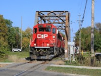 CP 2270 leads CP 3119, CP 2276 and 28 cars across the swing bridge and over the Trent-Severn Waterway in Peterborough.