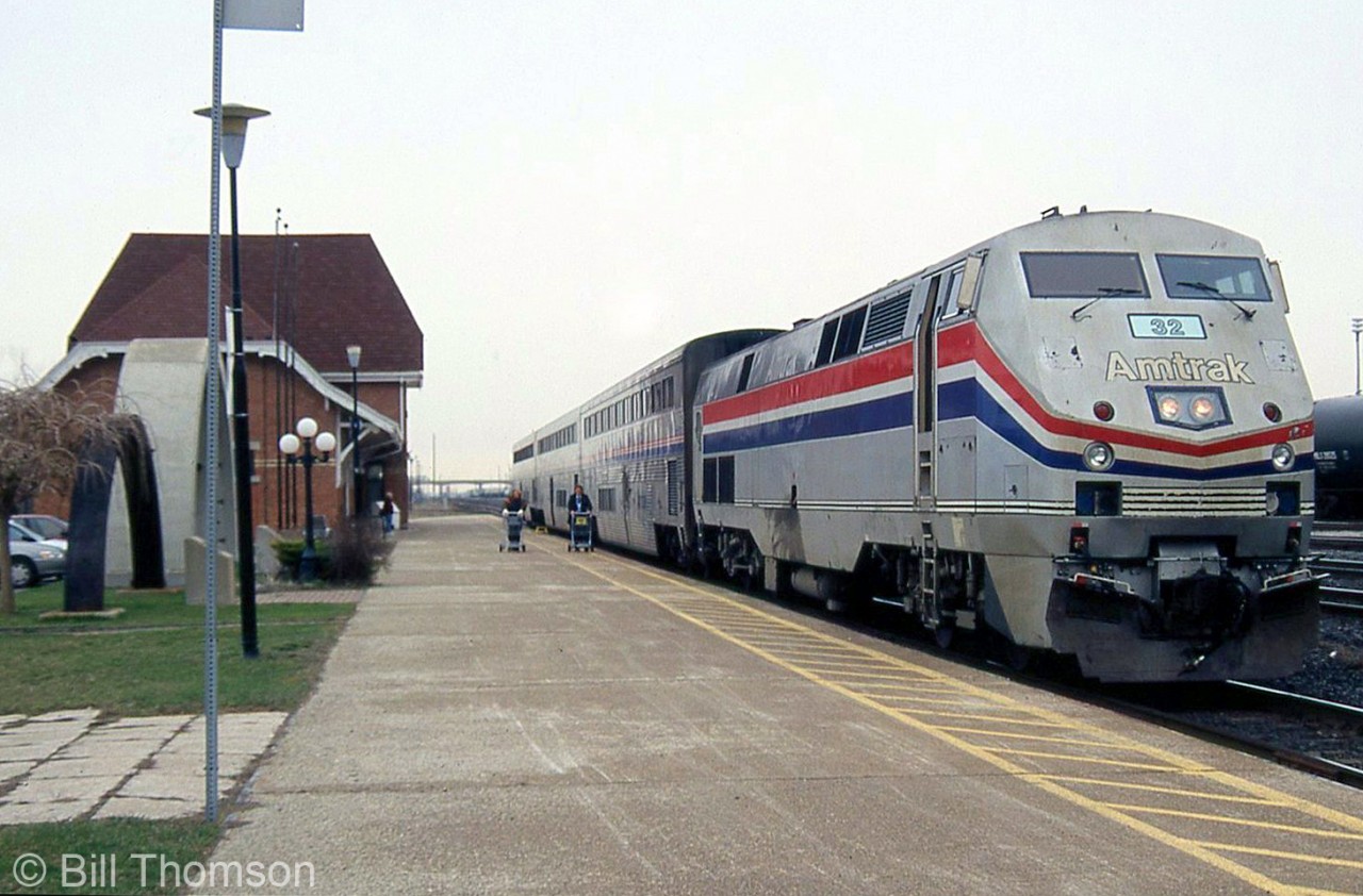 The last VIA-Amtrak "International" from Toronto to Chicago, lead by P42 32, is shown stopped at Sarnia station before entering the tunnel to the USA. On the left, note comparative frames of old and new tunnel sections on display on the station grounds.